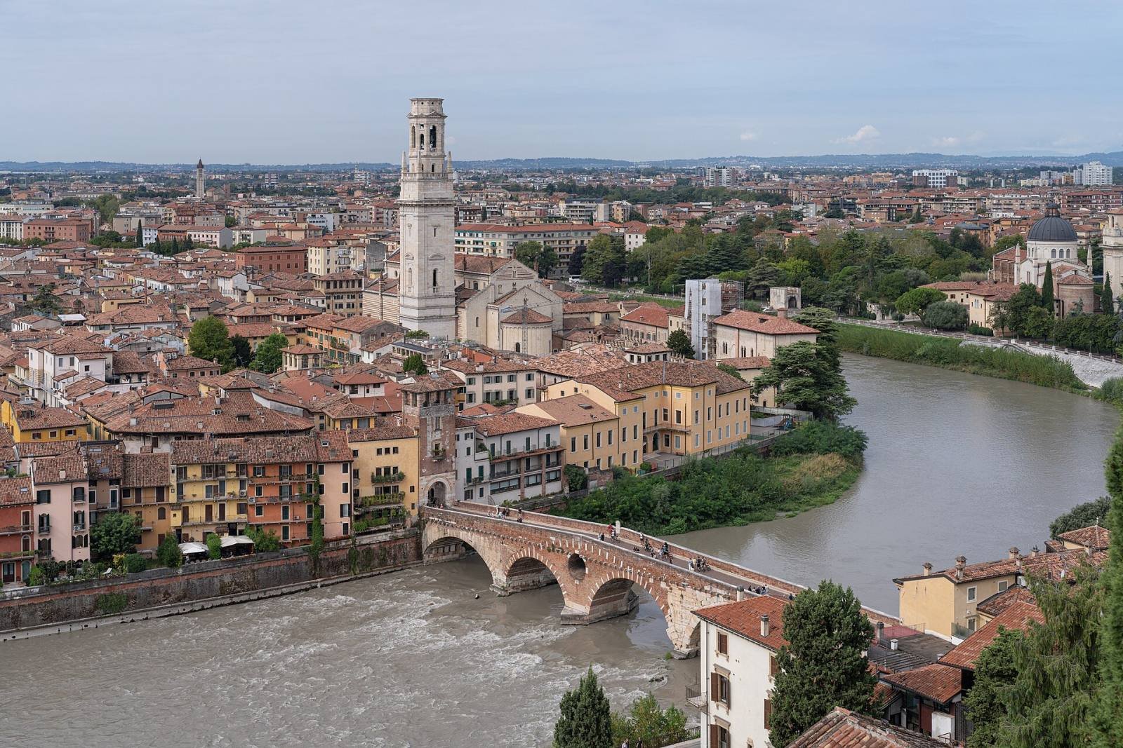 Verona’s old town and the Ponte Pietra bridge on a bend of the Adige river, seen from above