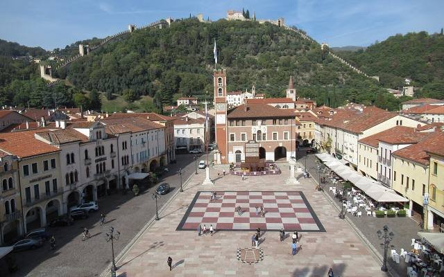 The chessboard square of Marostica below the castle walls climbing the hill