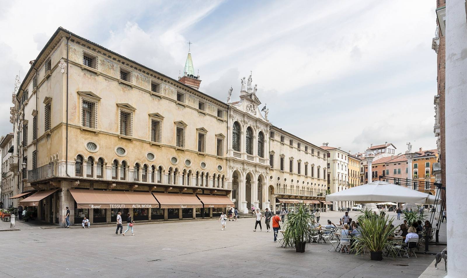 Piazza dei Signori in Vicenza, with palaces, café umbrellas and a tall clock tower