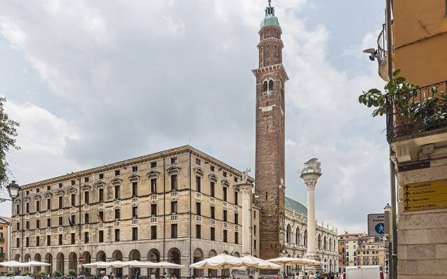 Piazza dei Signori in Vicenza with the tall Torre Bissara and café tables